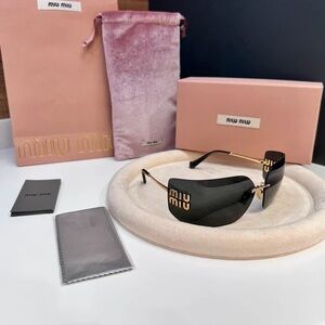 Miu Miu Black Sunglasses with Gold Accents